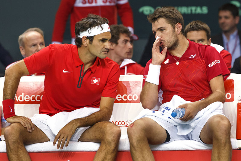 Switzerland's Stanislas Wawrinka, right, speaks with his doubles partner Roger Federer, left, during their doubles match of the Davis Cup World Group Quarterfinal match between Switzerland and Kazakhstan  in Geneva, Switzerland, Saturday, April 5, 2014.  Roger Federer and Stanislas Wawrinka lost the doubles match to Andrey Golubev and Aleksandr Nedovyesov on Saturday, giving Kazakhstan a 2-1 lead over Switzerland in the Davis Cup quarterfinals. (AP Photo/Keystone,Salvatore Di Nolfi)