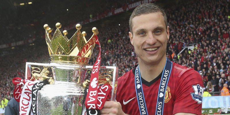 MANCHESTER, ENGLAND - MAY 12:  Nemanja Vidic of Manchester United celebrates with the Premier League trophy after the Barclays Premier League match between Manchester United and Swansea at Old Trafford on May 12, 2013 in Manchester, England.  (Photo by John Peters/Man Utd via Getty Images)